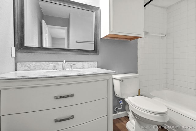 bathroom featuring vanity, wood-type flooring, and toilet