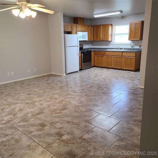 kitchen featuring ceiling fan, white appliances, sink, and light tile patterned floors