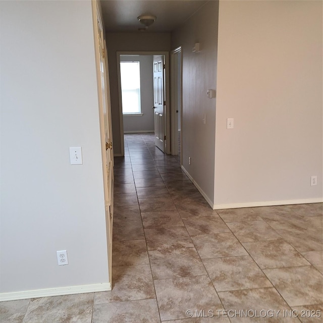 hallway featuring light tile patterned flooring