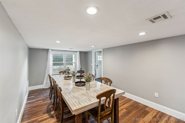 dining area featuring dark wood-type flooring