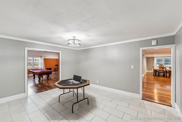 dining area with crown molding, pool table, light hardwood / wood-style floors, and a textured ceiling