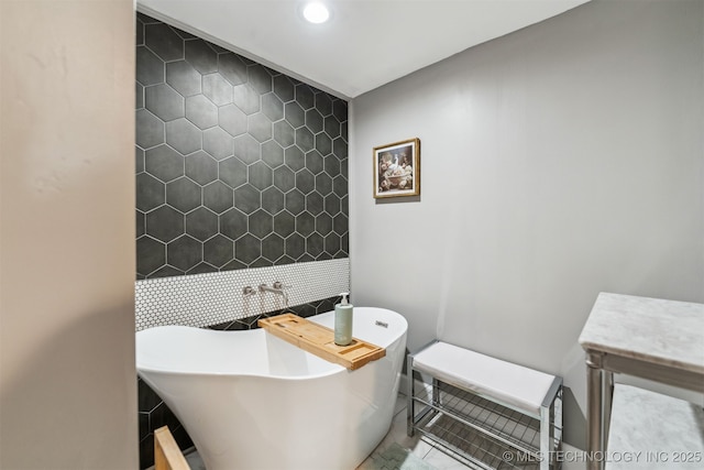 bathroom with tile walls and a bathtub