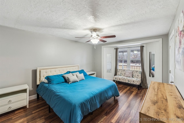 bedroom with ceiling fan, dark hardwood / wood-style flooring, and a textured ceiling