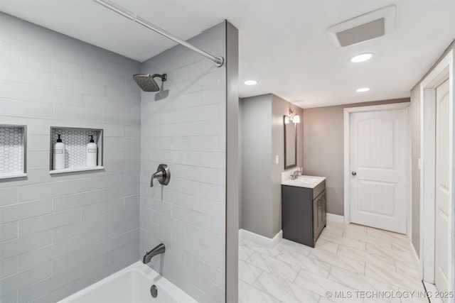 bathroom with vanity and tiled shower / bath