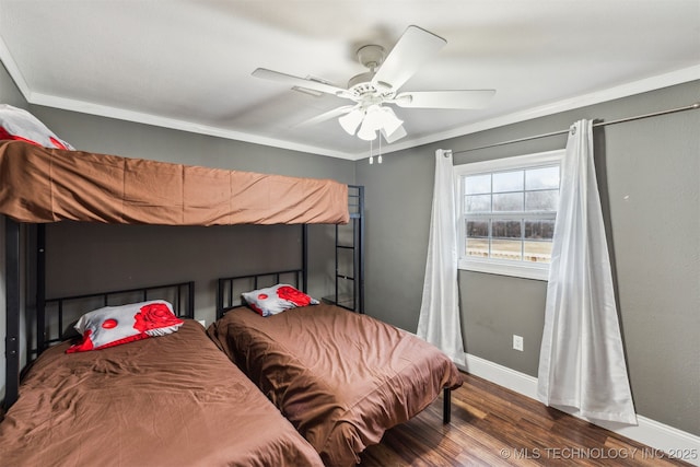 bedroom featuring ornamental molding, dark wood-type flooring, and ceiling fan