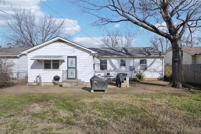 rear view of property featuring a yard