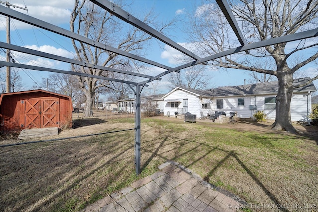 view of yard with a storage unit and a pergola