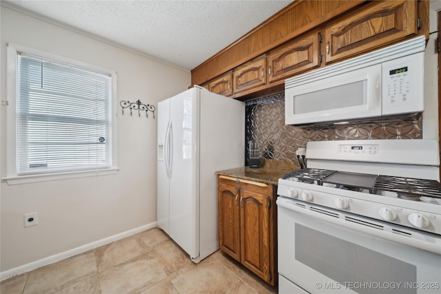 kitchen with tasteful backsplash, white appliances, dark stone counters, and a textured ceiling