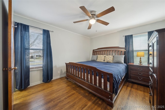 bedroom featuring ornamental molding, dark hardwood / wood-style floors, and ceiling fan