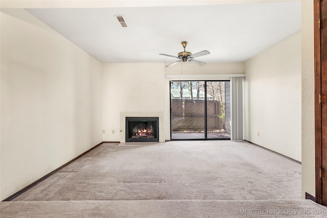 unfurnished living room with ceiling fan and light carpet