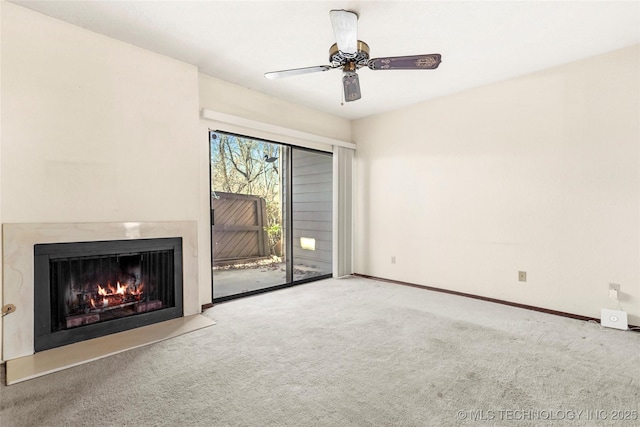 unfurnished living room featuring light colored carpet and ceiling fan