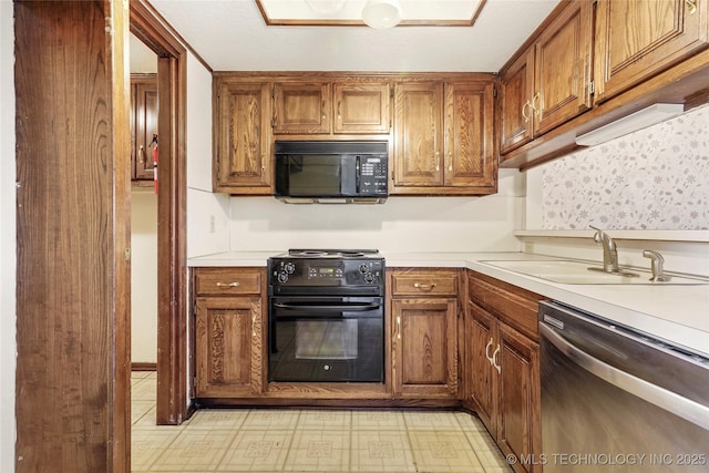 kitchen with sink and black appliances