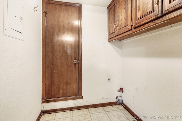 washroom featuring cabinets and electric panel