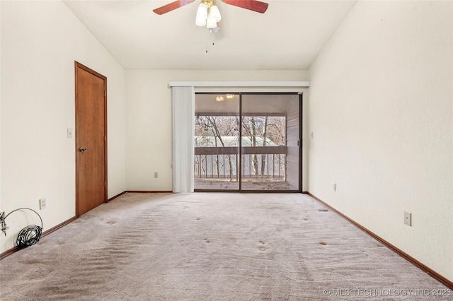 carpeted spare room with ceiling fan and vaulted ceiling