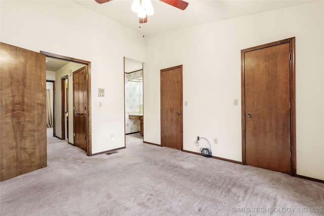 carpeted spare room with ceiling fan