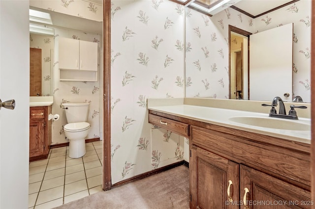 bathroom with tile patterned flooring, vanity, and toilet