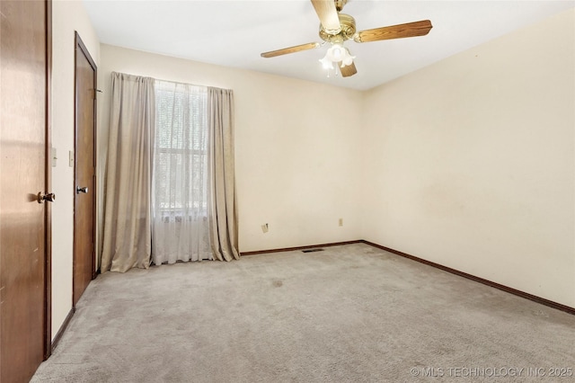 carpeted empty room featuring ceiling fan