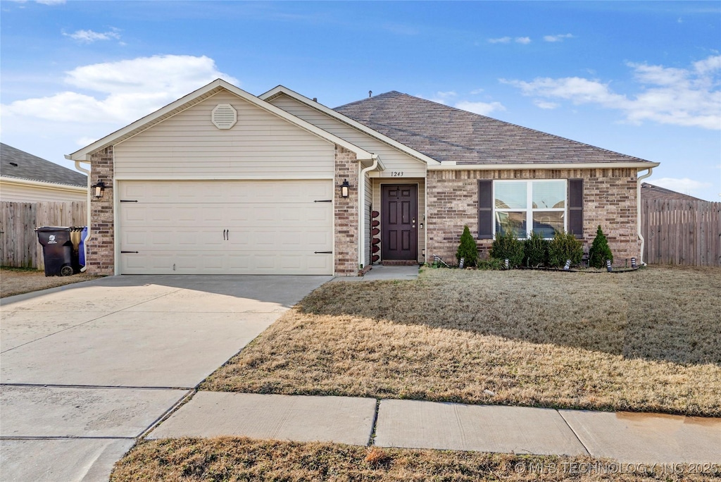 ranch-style house with a garage and a front lawn