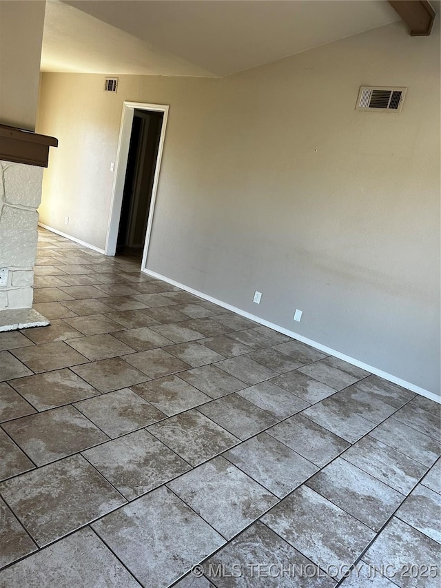 empty room featuring lofted ceiling