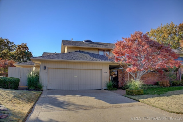 view of front of property featuring a garage and a front yard