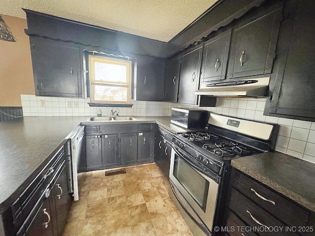 kitchen with sink, decorative backsplash, a textured ceiling, and appliances with stainless steel finishes