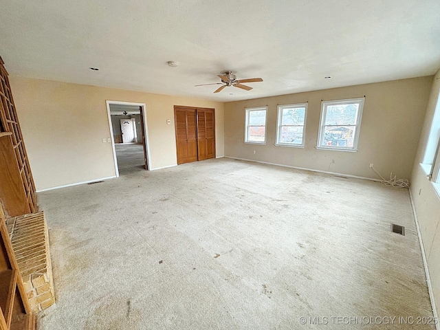 unfurnished bedroom with ceiling fan and light colored carpet