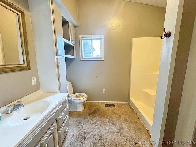 bathroom featuring walk in shower, vanity, and toilet