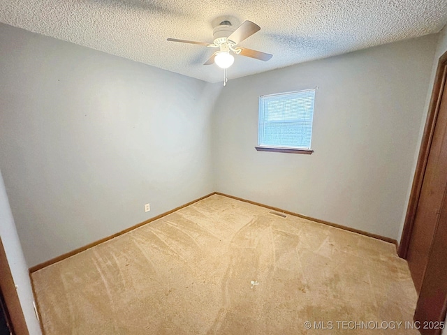 carpeted empty room with a textured ceiling and ceiling fan