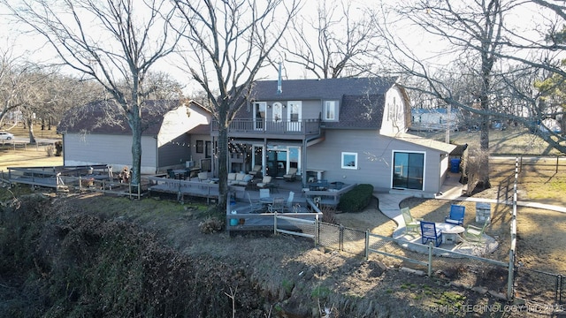 back of property featuring a patio and a balcony