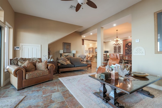 living room featuring ceiling fan with notable chandelier