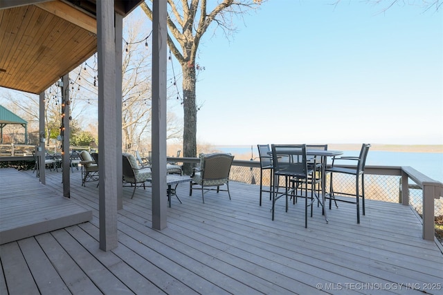 wooden terrace featuring a water view