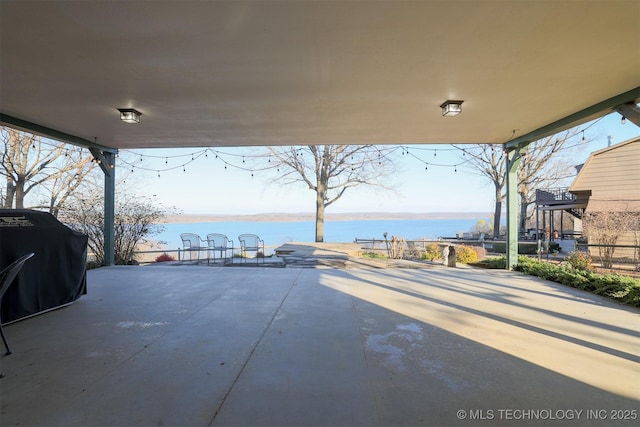 view of patio / terrace with a water view and grilling area