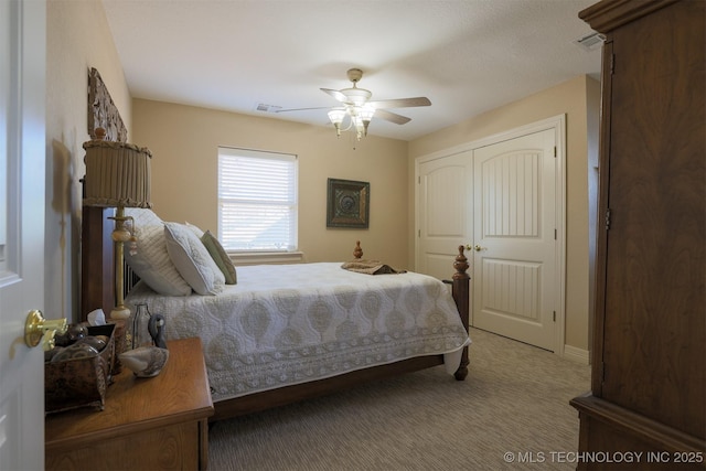 carpeted bedroom featuring ceiling fan and a closet