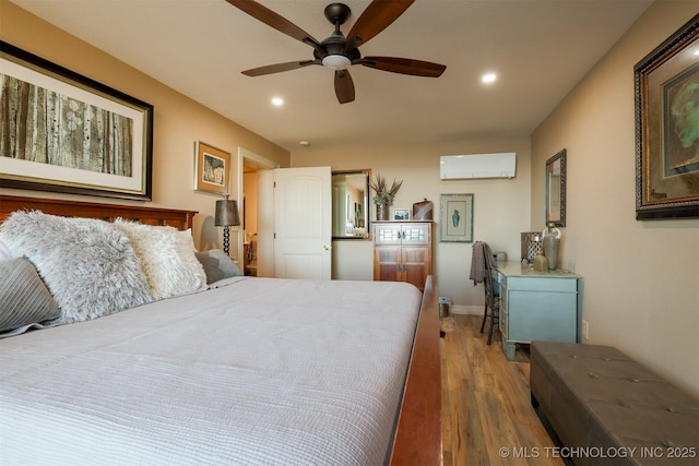 bedroom featuring a wall unit AC, hardwood / wood-style flooring, and ceiling fan