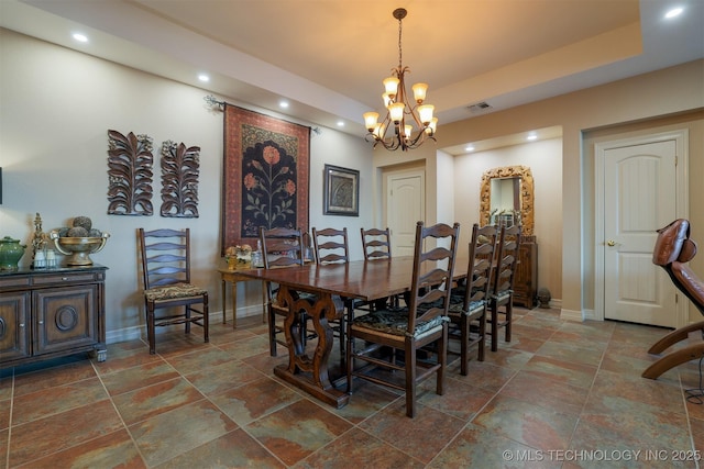 dining room featuring a tray ceiling and a notable chandelier