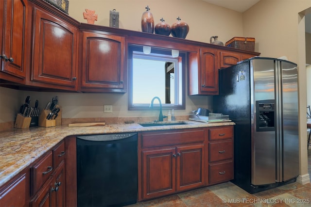 kitchen with sink, light stone countertops, stainless steel fridge with ice dispenser, and dishwasher