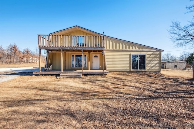 back of property featuring a deck