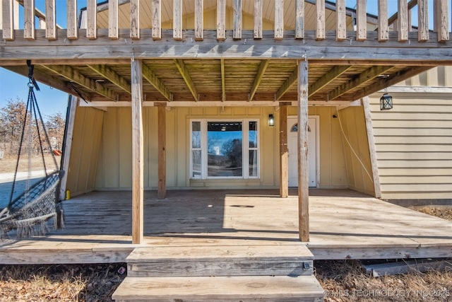 view of exterior entry with a deck