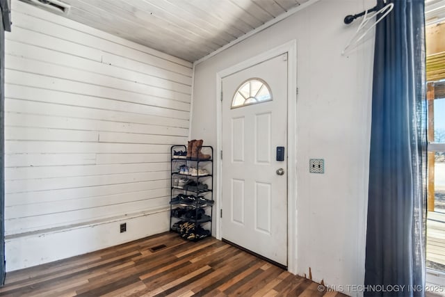 entryway featuring wooden walls, wood ceiling, and dark hardwood / wood-style flooring