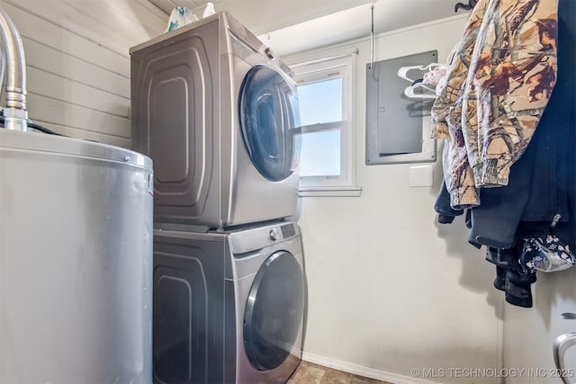 clothes washing area with electric panel, water heater, and stacked washing maching and dryer