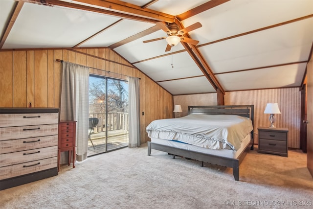 carpeted bedroom featuring ceiling fan, access to exterior, lofted ceiling with beams, and wood walls