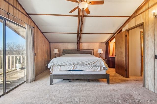 bedroom featuring vaulted ceiling, wood walls, light colored carpet, and access to outside