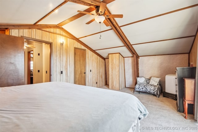 carpeted bedroom featuring vaulted ceiling, ceiling fan, and wood walls