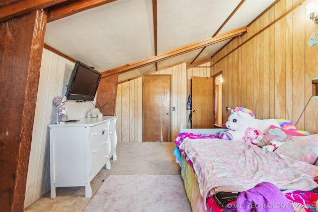 carpeted bedroom featuring wooden walls