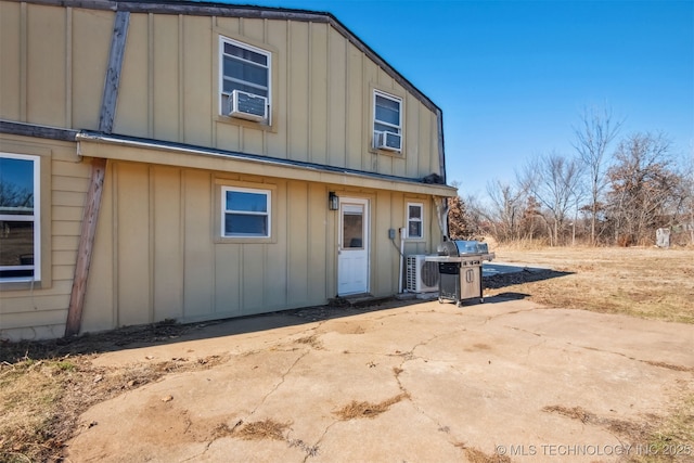 rear view of property featuring a patio and cooling unit