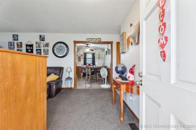 interior space with ceiling fan and carpet