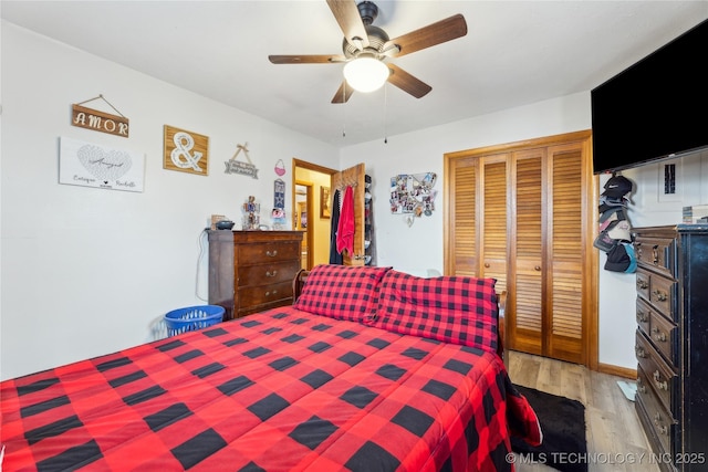 bedroom with ceiling fan, a closet, and light hardwood / wood-style flooring