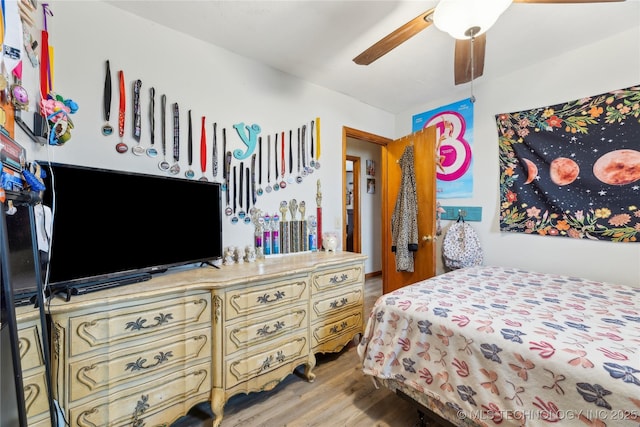 bedroom featuring hardwood / wood-style floors and ceiling fan