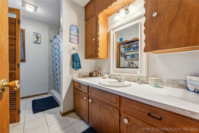 bathroom with tile patterned floors, vanity, and a shower with shower curtain