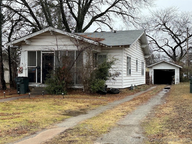 bungalow with an outbuilding and a garage